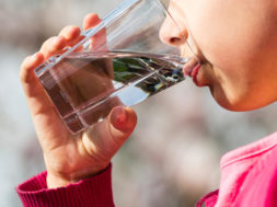 Girl drinking water from glass