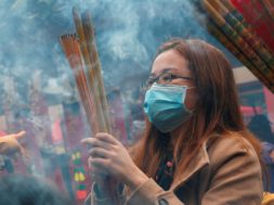 Worshippers wear masks to prevent an outbreak of a new coronavirus as they make offerings of incense sticks during a Lunar New Year celebration at Che Kung Temple, in Hong Kong