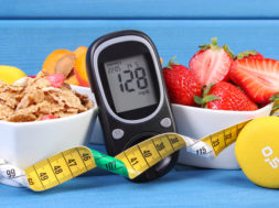 Glucose meter with sugar level, healthy food, dumbbells and centimeter, diabetes, healthy and sporty lifestyle