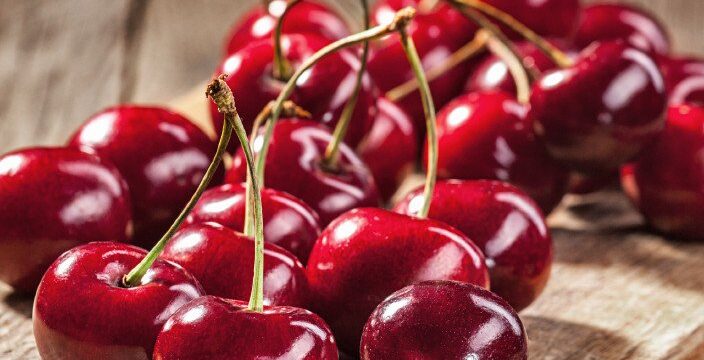 Ripe red cherries on old boards