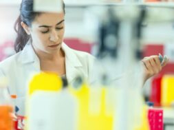 Concentrated chemist holding pipette at laboratory