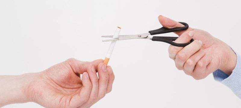 close-up-female-s-hand-cutting-cigarette-with-scissor-from-man-s-hand_23-2148185395