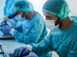 medical-workers-hazmat-suit-working-with-laptop-computer-micoroscope-inside-laboratory-hospital-during-coronavirus-outbreak_166273-983