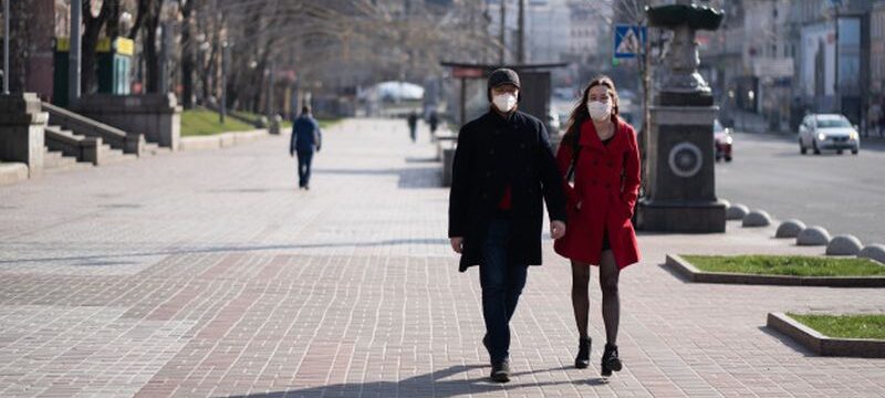 people-facial-protective-masks-almost-empty-street_1153-5033