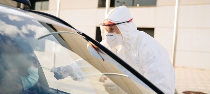 doctor-doing-pcr-test-covid-19-patient-through-car-window_147764-743