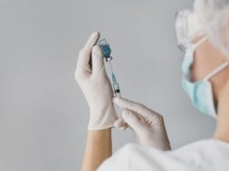 doctor-holding-syringe-vaccine_23-2148847218