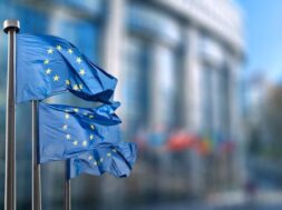 european-union-flag-against-parliament-brussels-belgium_338799-2787