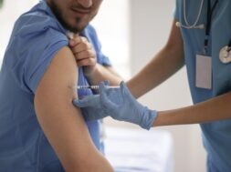 female-doctor-vaccinating-her-colleague_23-2148880503