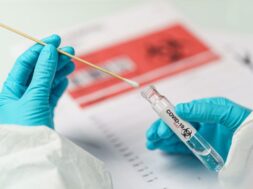 hand-holding-covid-19-swab-collection-kit-specimen-sample-testing-process_46370-1598