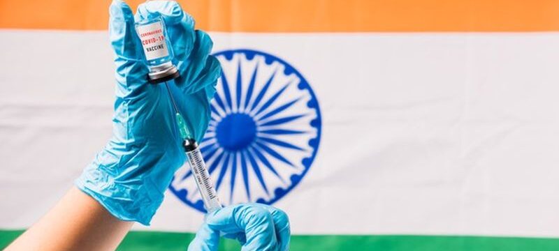 hands-doctor-wear-gloves-holding-coronavirus-vial-vaccine-syringe-flag-india_143683-1591