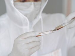 man-protective-suit-glasses-working-laboratory_1157-34427