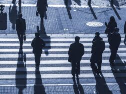 silhouette people walk on pedestrian crosswalk at the junction s