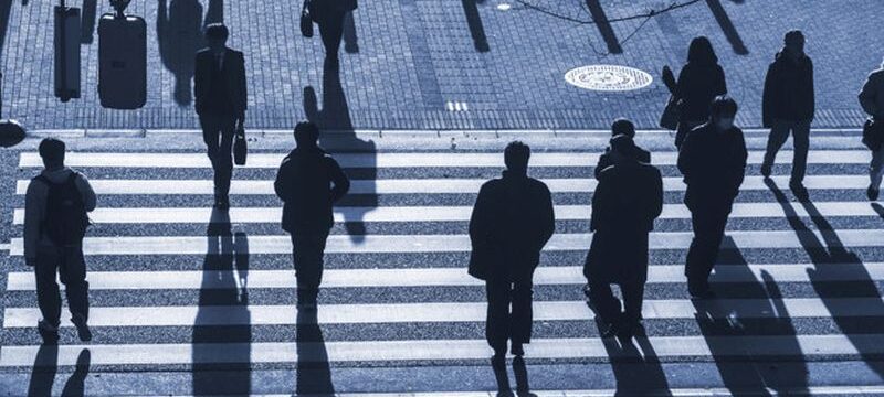 silhouette people walk on pedestrian crosswalk at the junction s