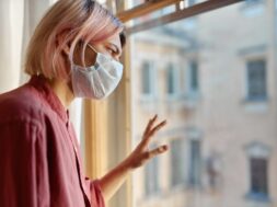teenage-girl-with-pinkish-hair-standing-front-closed-window-with-hand-glass-looking-outside-while-staying-home-during-quarantine-coronavirus-pandemic-social-distancing-concept_343059-1917