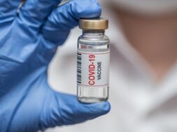 vaccine-ampoule-from-coronavirus-doctor-keeps-blue-gloves-close-up_303157-278
