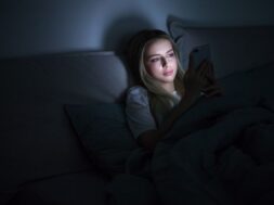woman-lying-bed-using-smartphone-night_165285-414