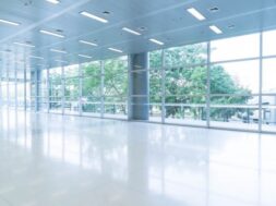 blurred-abstract-background-interior-view-looking-out-toward-empty-office-lobby-entrance-doors-glass-curtain-wall-with-frame_1339-6367
