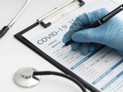 close-up-doctor-completing-covid-medical-form_23-2148747819