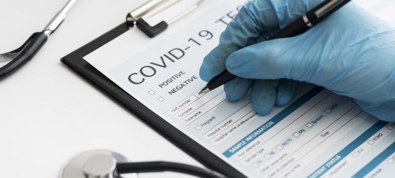 close-up-doctor-completing-covid-medical-form_23-2148747819