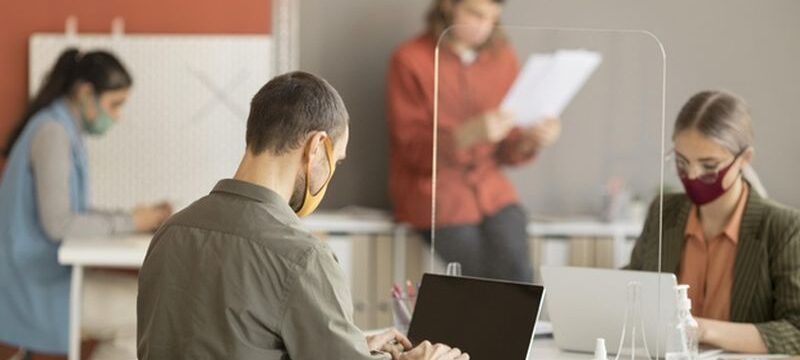 co-workers-wearing-face-mask-work_23-2148727682