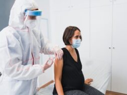 doctor-giving-vaccine-pregnant-woman-against-covid-19-flu-whooping-cough_147764-772