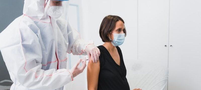 doctor-giving-vaccine-pregnant-woman-against-covid-19-flu-whooping-cough_147764-772