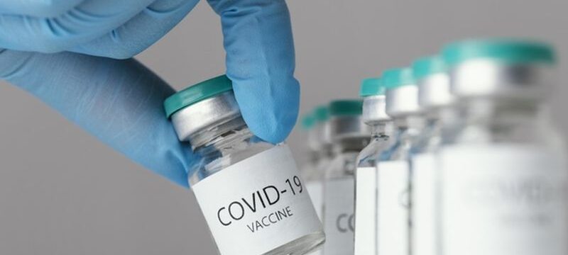 doctor-holding-covid-19-vaccine-bottle_23-2148920209