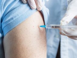 doctor-holds-syringe-with-coronavirus-vaccine-his-hands-injects-vaccine-into-shoulder-elderly-patient-clinic_308589-1586