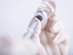 female-doctor-hands-holding-syringe-vaccine_53476-4959