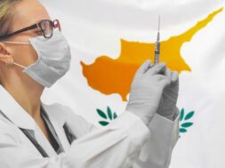 female-doctor-nurse-gloves-holding-syringe-vaccination-against-cyprus-flag_156719-731