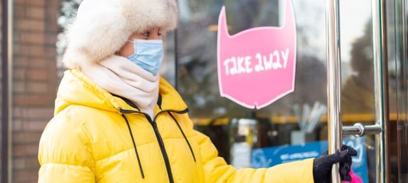 happy-young-woman-door-restaurant-cold-winter-day-lettering-takeaway-food_343596-4738