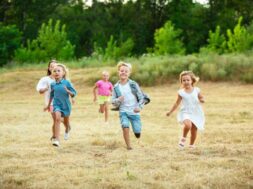 kids-children-running-meadow-summer-s-sunlight_155003-13021