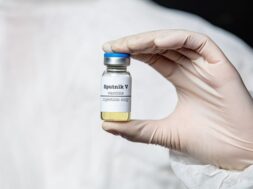 medic-hold-vaccine-container-with-russian-sputnik-v_87910-12225