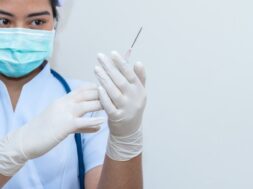 nurse-holding-medical-syringe-with-needle-ampule-getting-ready-patient-injection_55877-110