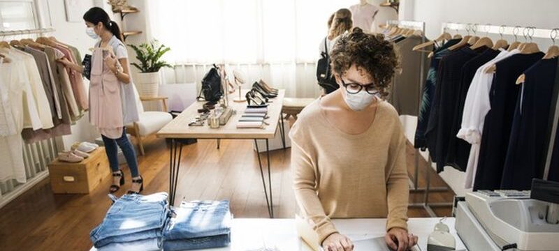 people-wearing-mask-clothing-store-shopping-new-normal_53876-96179