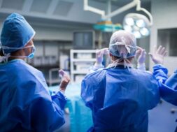 rear-view-surgeons-preparing-operation-operation-room_1170-2253