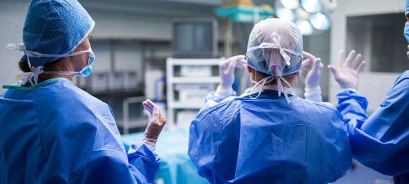 rear-view-surgeons-preparing-operation-operation-room_1170-2253