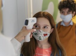 teacher-with-medical-mask-checking-children-s-temperature-school_23-2148848280