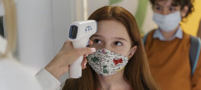 teacher-with-medical-mask-checking-children-s-temperature-school_23-2148848280