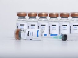 transparent-glass-vials-with-covid-19-vaccine-syringe_109656-942