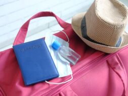 travel-suitcase-with-mask-passport-hand-sanitizer_260672-3638