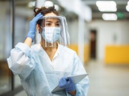 young-woman-nurse-adjusts-her-face-shield-hospital-corridor-during-coronavirus-pandemic-professional-medical-worker-portrait-work-place-healthcare-medicine-safety-concept_243724-802