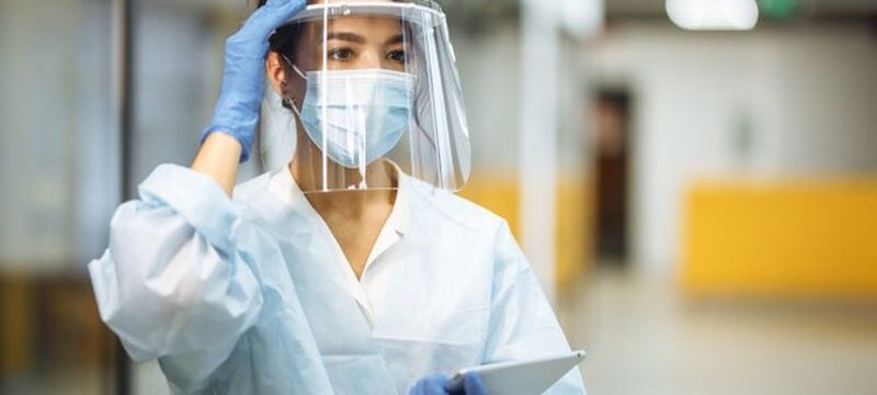 young-woman-nurse-adjusts-her-face-shield-hospital-corridor-during-coronavirus-pandemic-professional-medical-worker-portrait-work-place-healthcare-medicine-safety-concept_243724-802