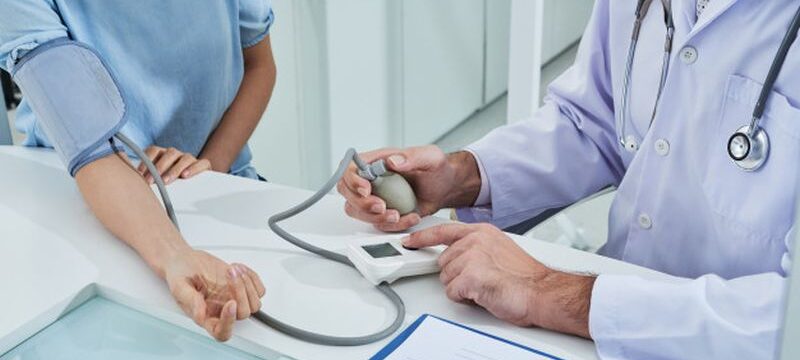 anonymous-doctor-measuring-blood-pressure-unrecognizable-patient-with-tonometer_1098-19336