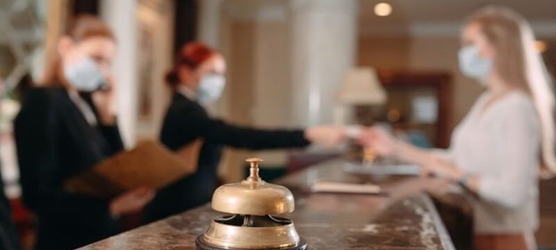 check-hotel-receptionist-counter-hotel-wearing-medical-masks-as-precaution-against-virus-young-woman-business-trip-doing-check-hotel_109285-8411