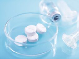 closeup-shot-white-pills-glass-dish-lab_181624-35938