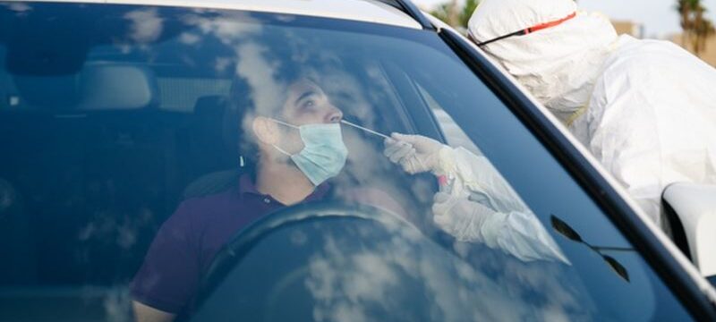 doctor-doing-pcr-test-covid-19-patient-through-car-window_147764-737