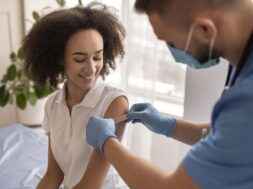 doctor-putting-patch-patient-arm-after-vaccination_23-2148880523