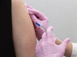 doctor-s-hand-pink-glove-injects-cavid-19-coronavirus-vaccine-into-vaccine-syringe-patient-s-arm-muscle-immunization-against-covid-19-coronavirus-covid-19-vaccination_404812-228