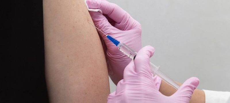 doctor-s-hand-pink-glove-injects-cavid-19-coronavirus-vaccine-into-vaccine-syringe-patient-s-arm-muscle-immunization-against-covid-19-coronavirus-covid-19-vaccination_404812-228